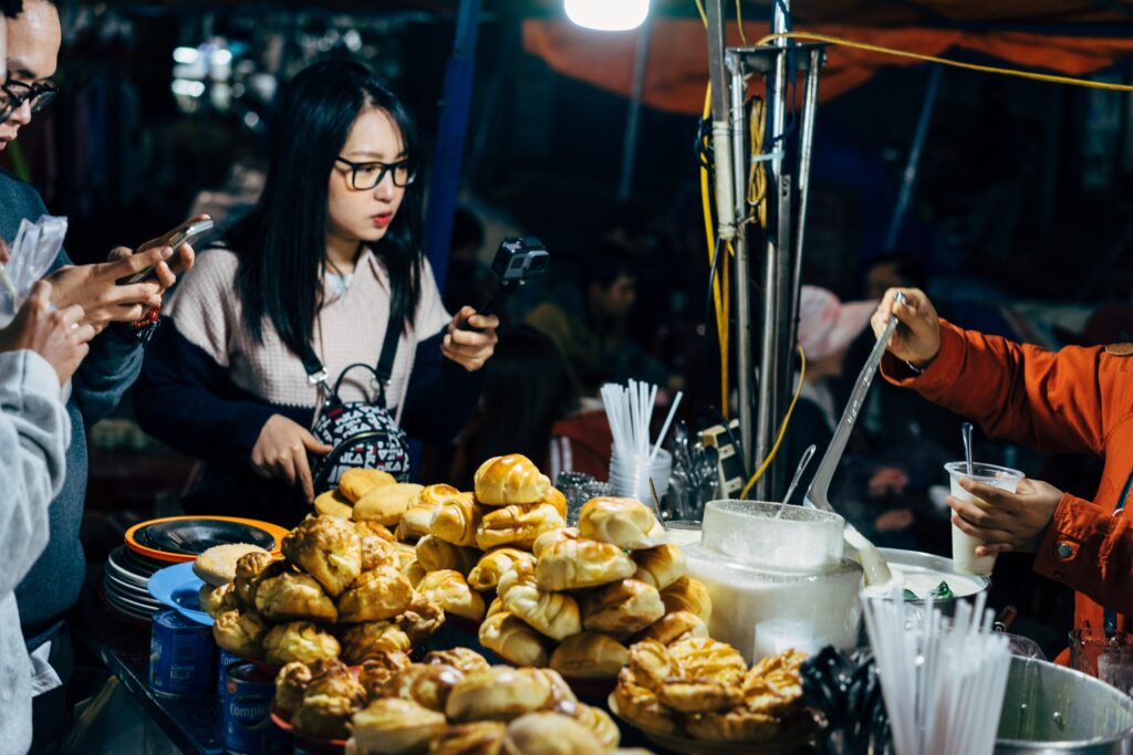 couple taking photos of street food